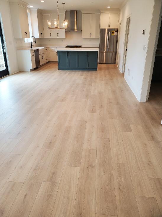 Flooring in an open space with a kitchen island.